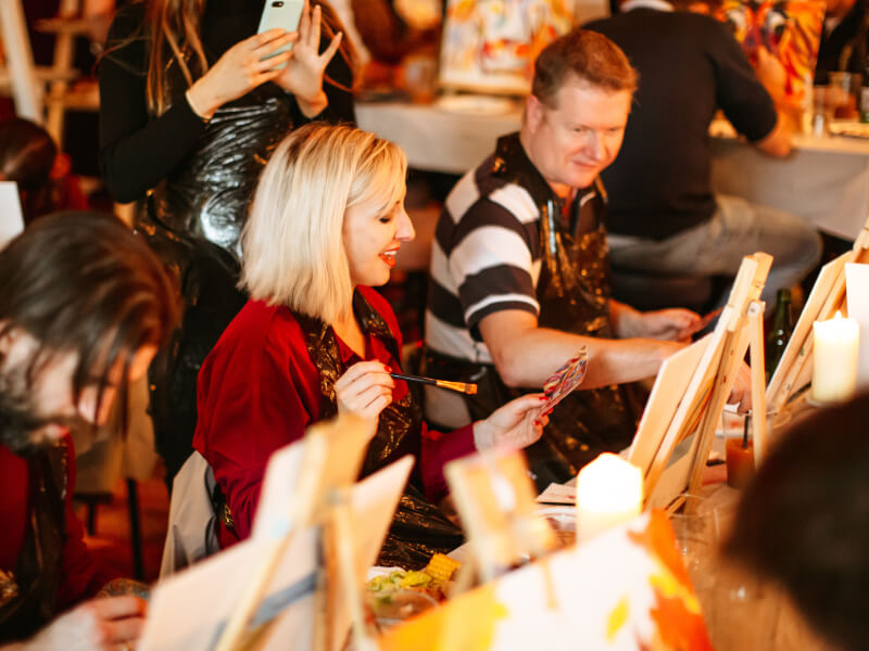 People painting in a class side by side